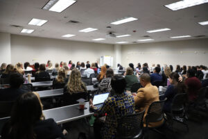 A crowded room listens to a panel of speakers during the Maternal & Child Health breakout session.