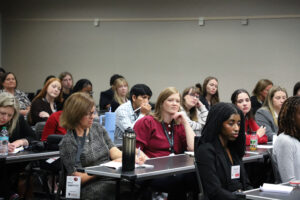 Audience members listen and take notes during the Maternal & Child Health breakout session.